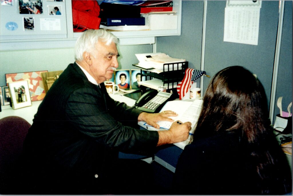Armando Moreno sitting at a desk teaching a Moreno employee English