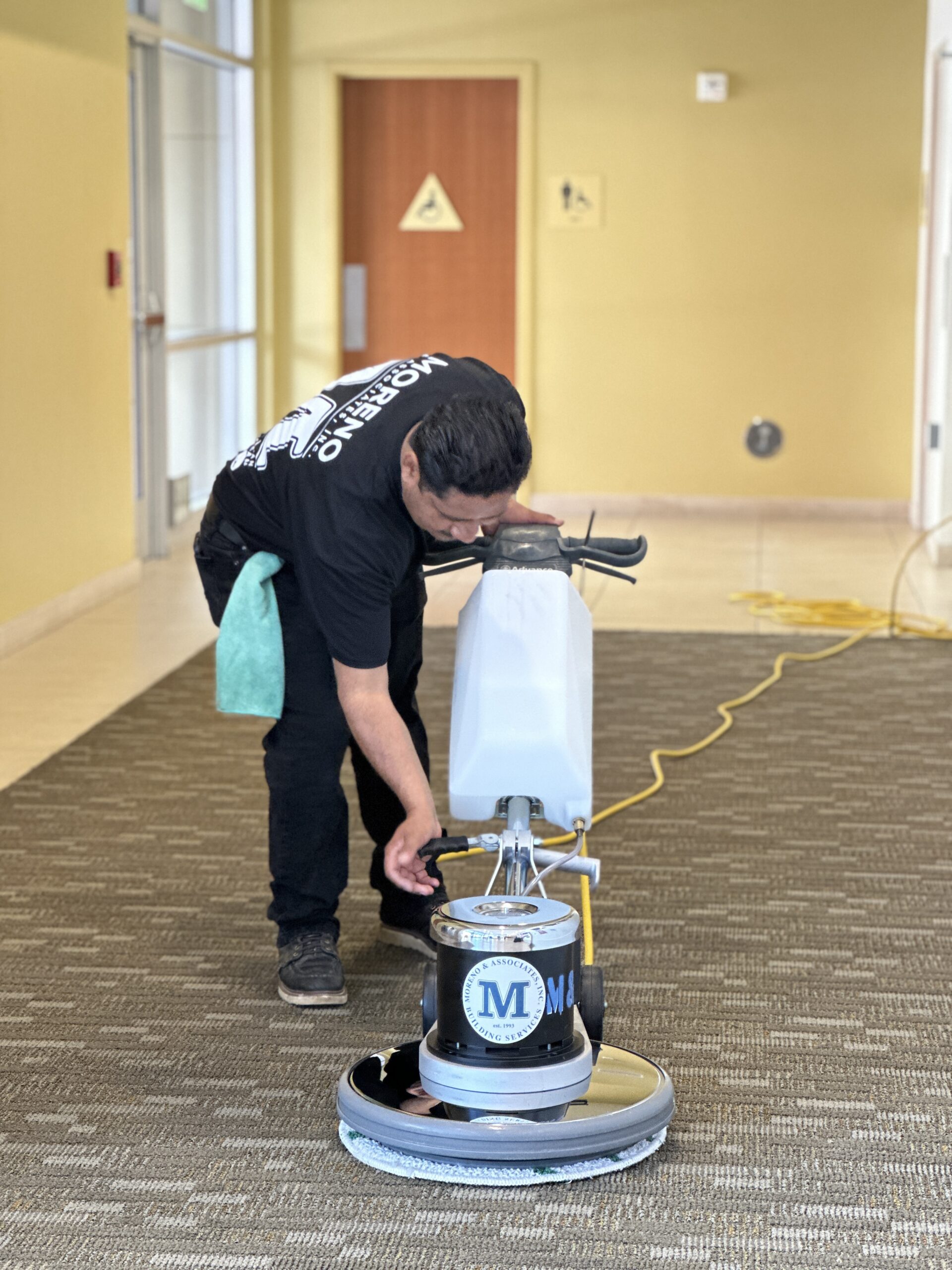 Moreno employee machine scrubbing carpet