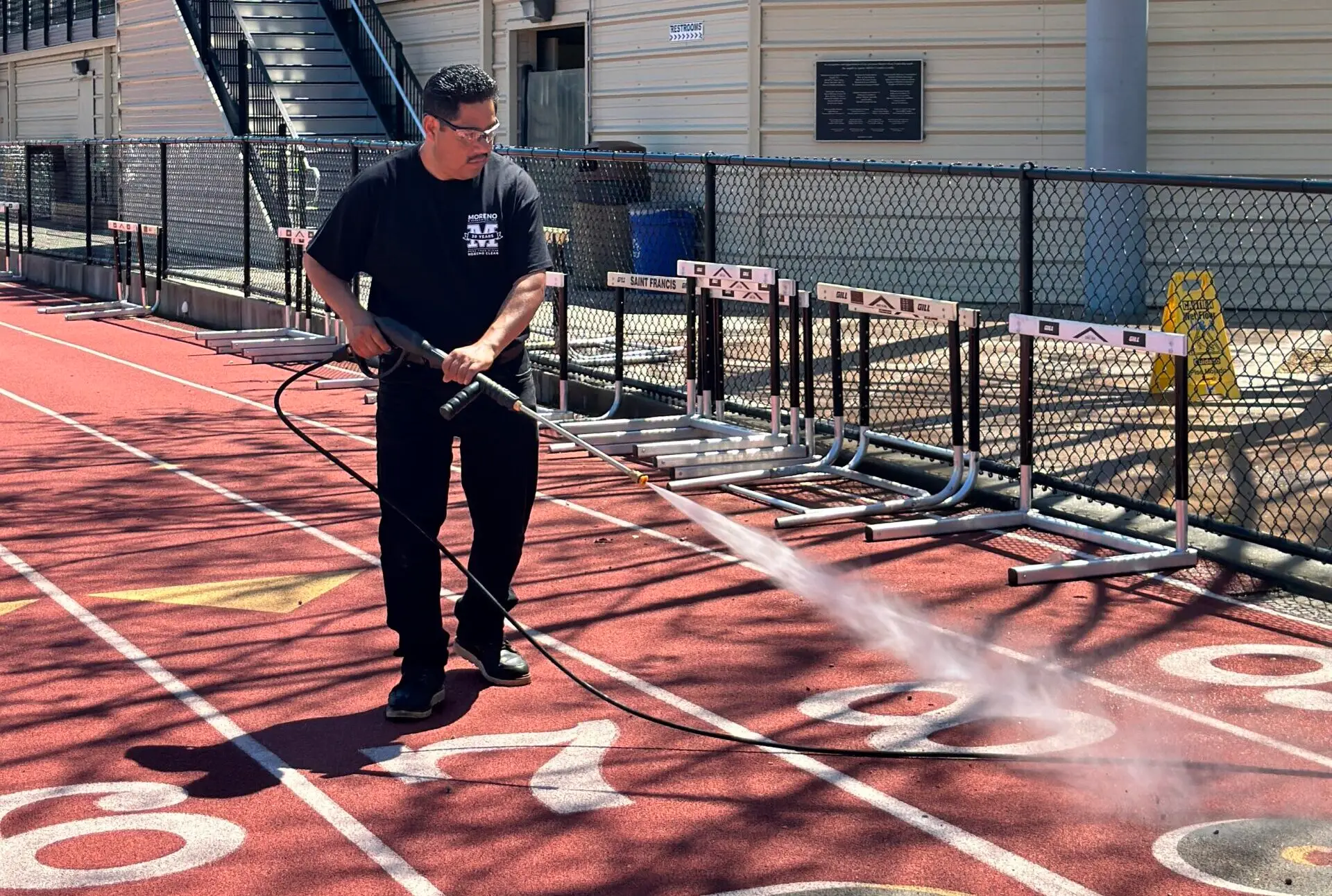 moreno employee pressure washing running track