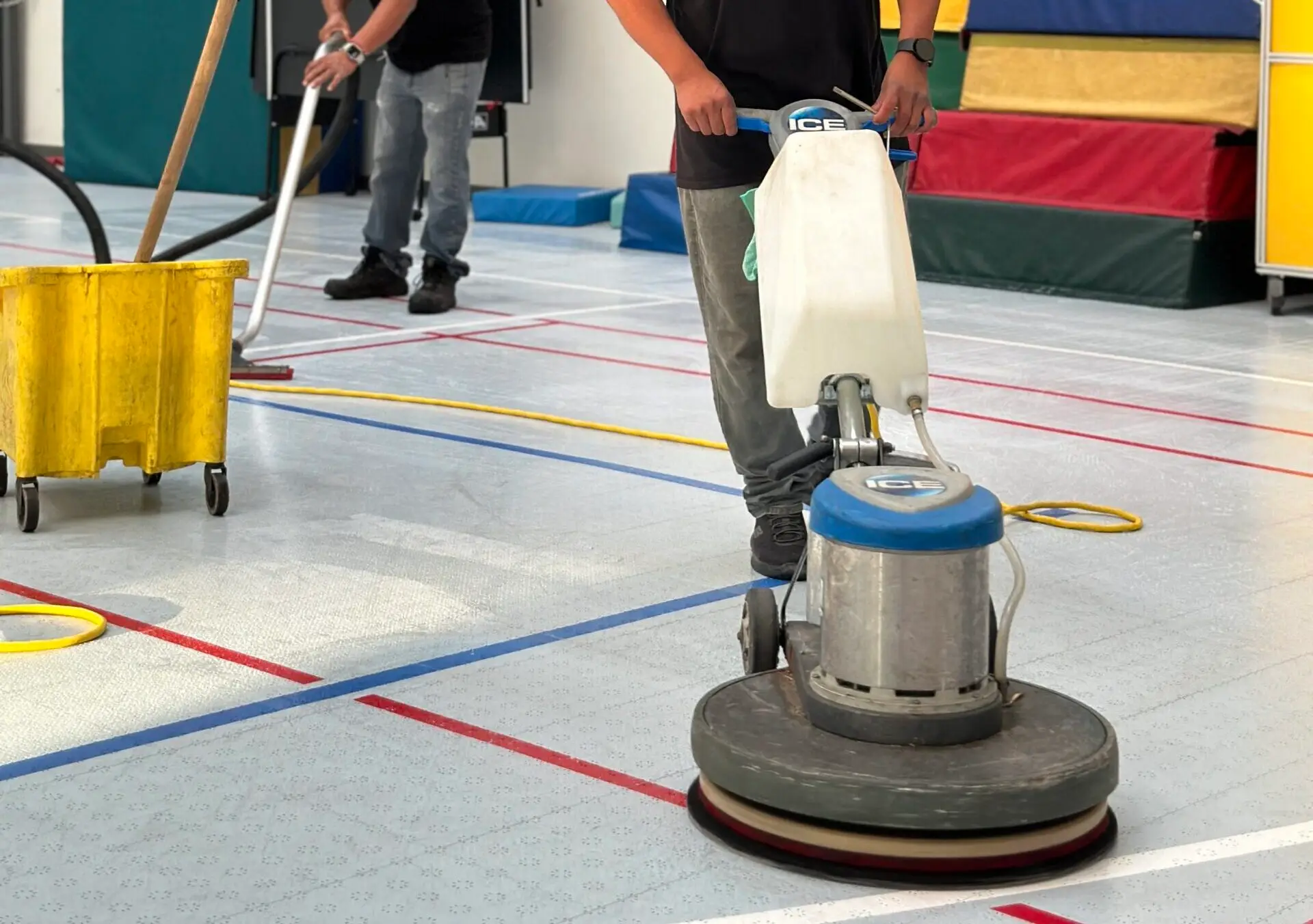 moreno employees using a floor machine to scrub plastic flooring