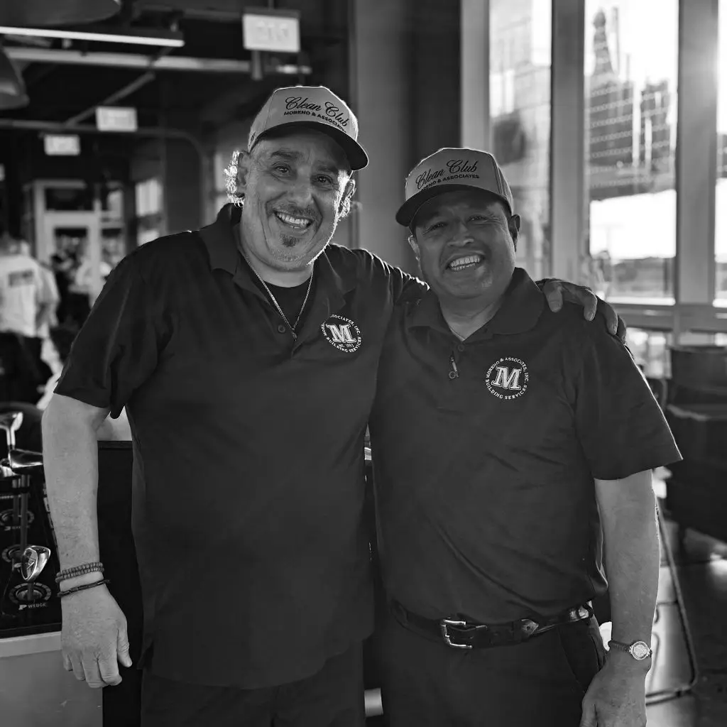 two male moreno employees smiling